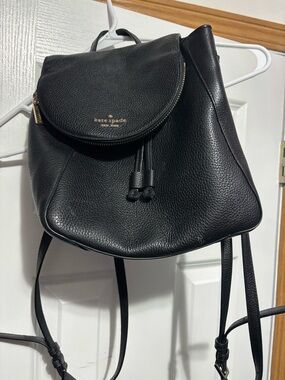 kate spade Black Pebbled Leather Drawstring Backpack with Gold Logo